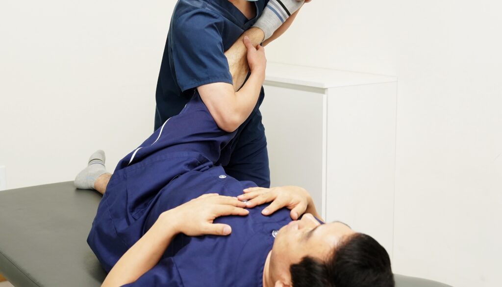 Physical therapist guiding a patient through a lower-limb rehabilitation session